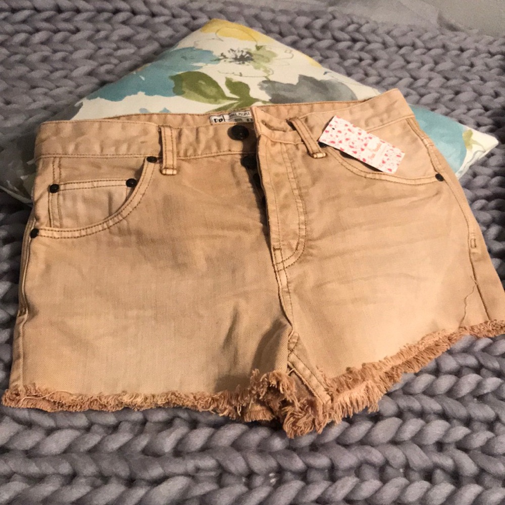 Khaki Free People shorts.